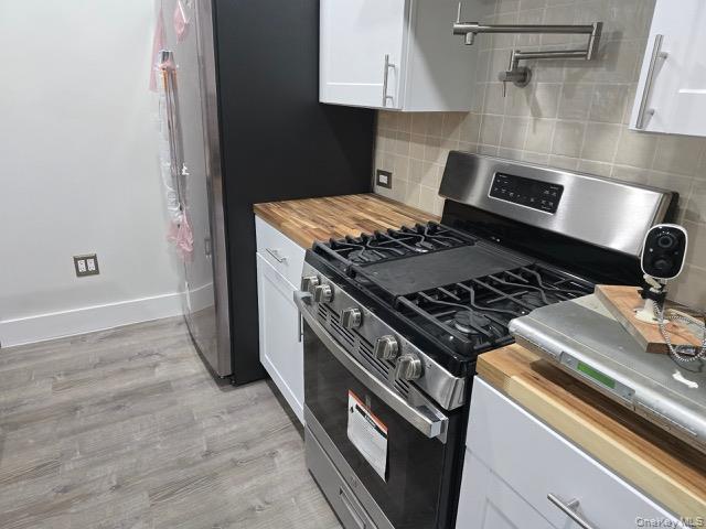 1003 Sacket Avenue Bronx, NY 10462 - Photo 14 of 28 a stove top oven sitting inside of a kitchen
