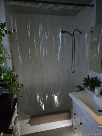 a bathroom with a shower curtain and a sink