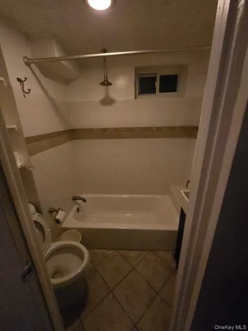 a bathroom with a tub and a shower