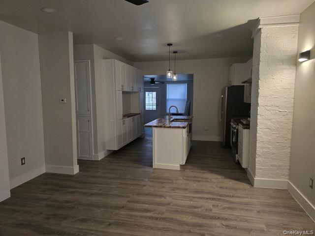 1003 Sacket Avenue Bronx, NY 10462 - Photo 4 of 28 a view of a kitchen with refrigerator and wooden floor