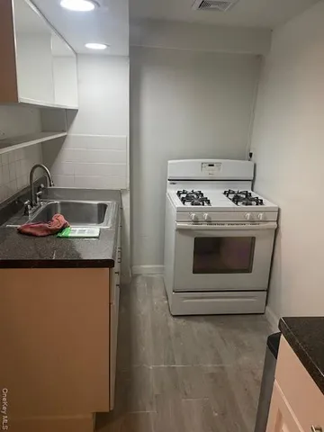 a stove top oven sitting inside of a kitchen