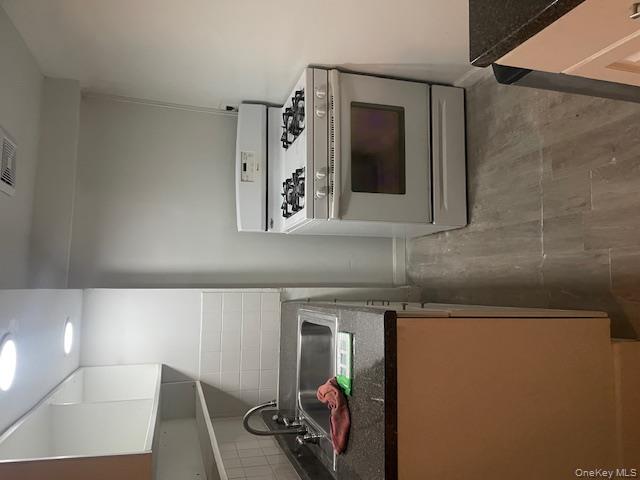 1003 Sacket Avenue Bronx, NY 10462 - Photo 9 of 28 a stove top oven sitting inside of a kitchen