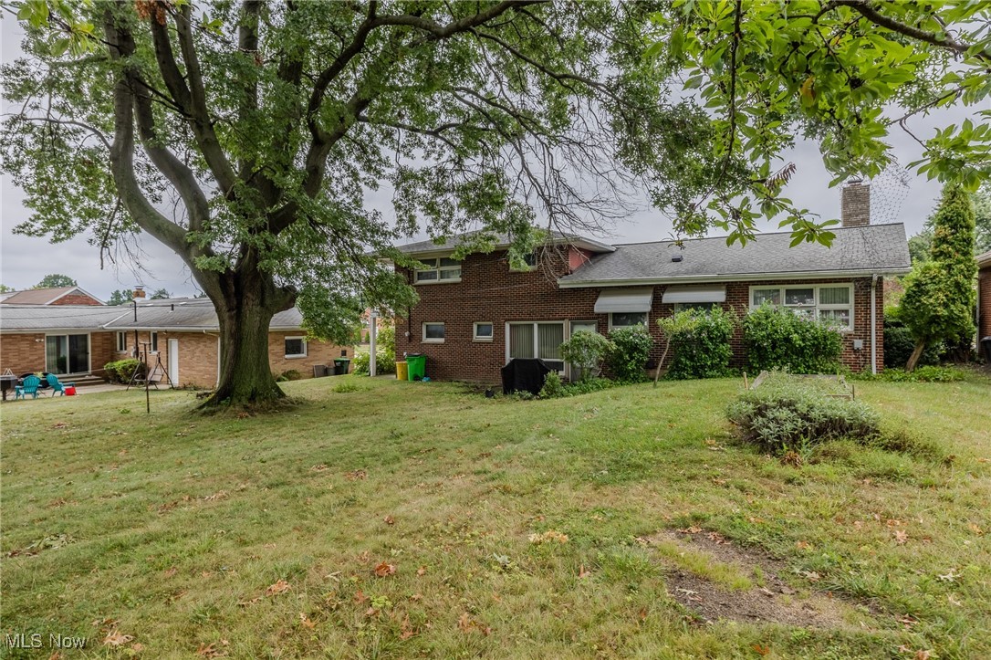 View of grassy yard featuring a patio