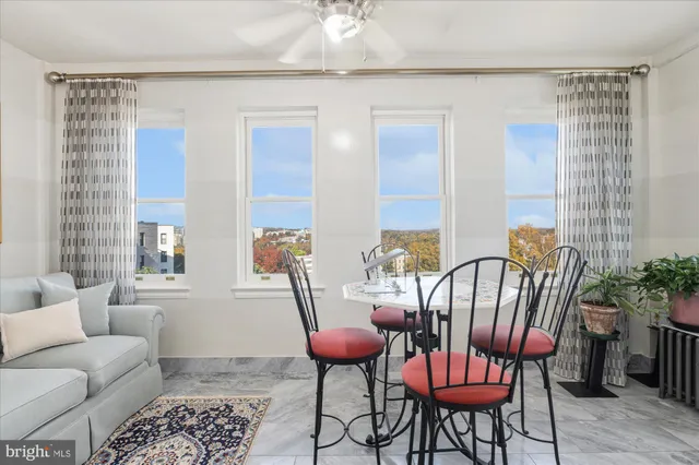 a living room with furniture a table and chairs