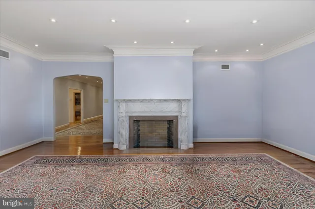 a view of empty room with a fireplace