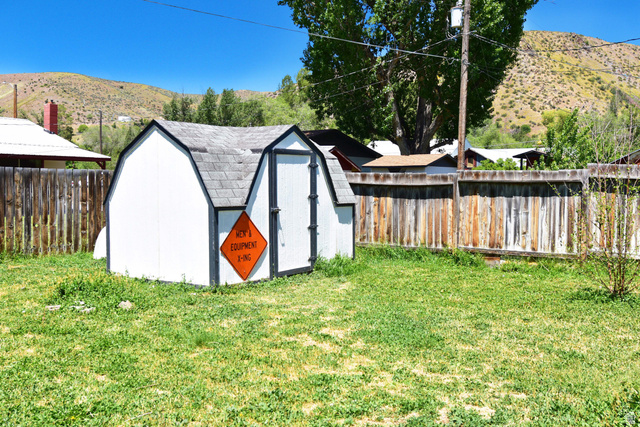 315 Park Street Inkom, ID 83245 - Photo 24 of 28 White storage shed with a gambrel roof and dark trim