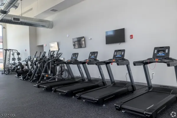 a room with gym equipment and a flat screen tv