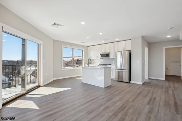 a view of a kitchen with wooden floor