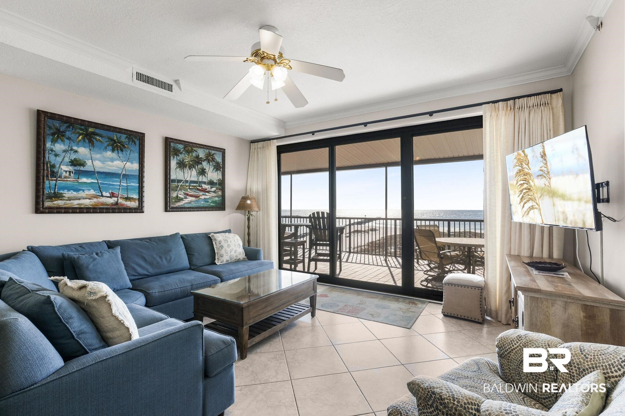 27284 Gulf Road, Unit 611 Orange Beach, AL 36561 - Photo 2 of 11 Living room with a ceiling fan, crown molding, and light tile patterned floors