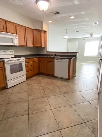 a kitchen with a stove a sink and a refrigerator