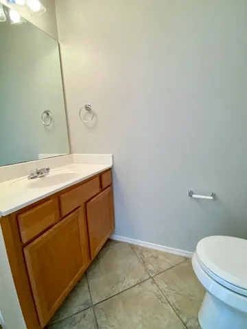 a bathroom with a sink a toilet and mirror