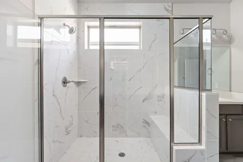 a bathroom with a glass shower door