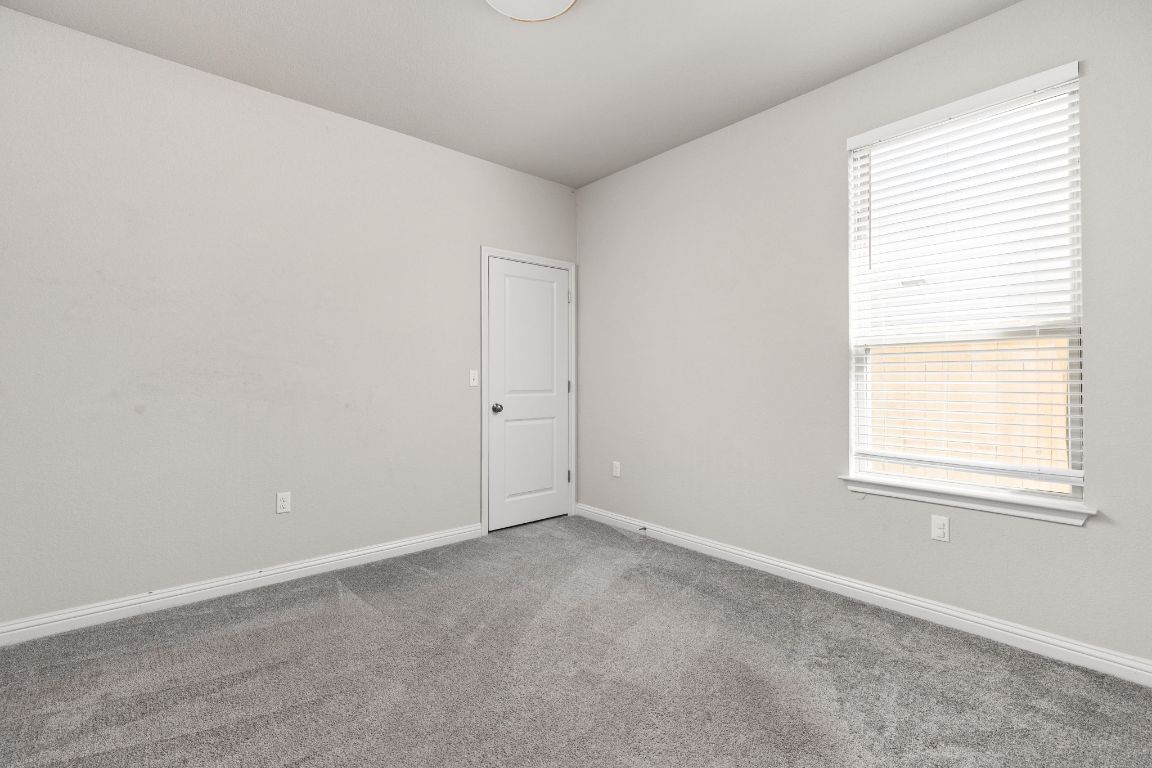 8408 Orizzonte Street Austin, TX 78744 - Photo 22 of 31 an empty room with a window