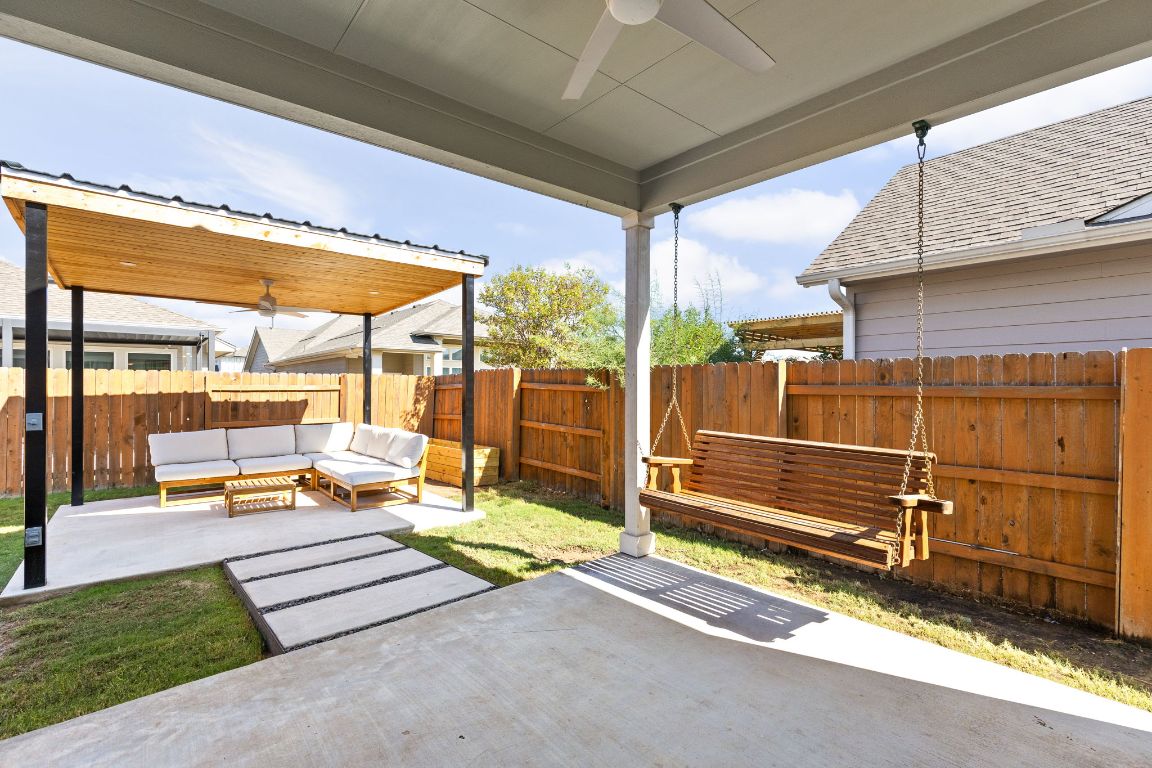 8408 Orizzonte Street Austin, TX 78744 - Photo 25 of 31 a view of a patio with a table chairs and wooden fence