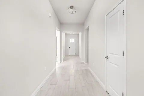 a view of a hallway with a white walls