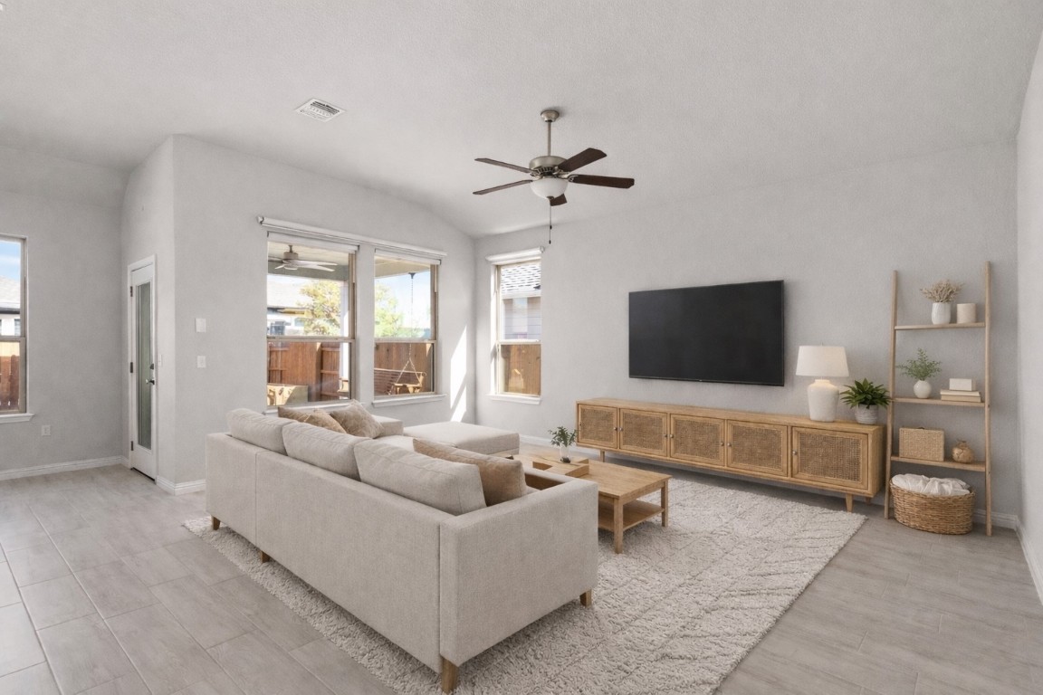 8408 Orizzonte Street Austin, TX 78744 - Photo 8 of 31 a living room with furniture and a flat screen tv