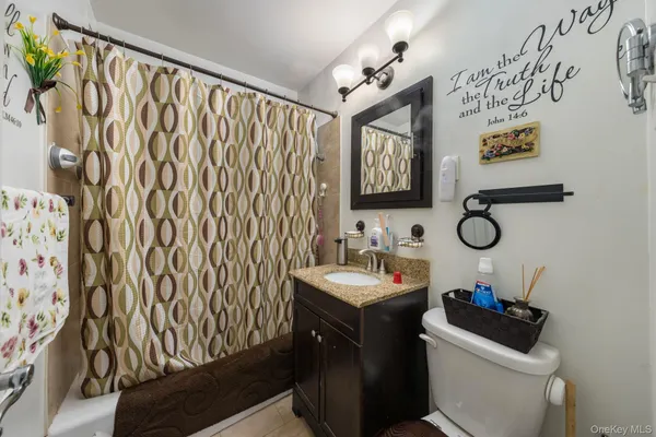 a bathroom with a toilet sink and vanity