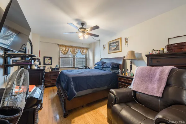 a bedroom with a bed a couch and dresser
