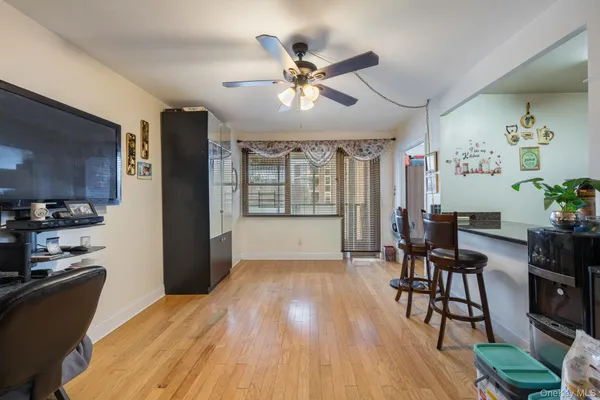 a workspace with wooden floor and a ceiling fan
