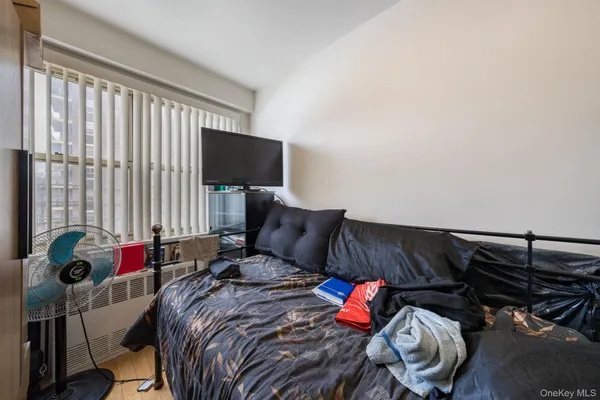 a bed sitting in a bedroom next to a window