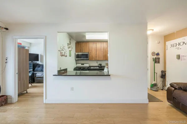 a kitchen with stainless steel appliances granite countertop a refrigerator a stove and a sink