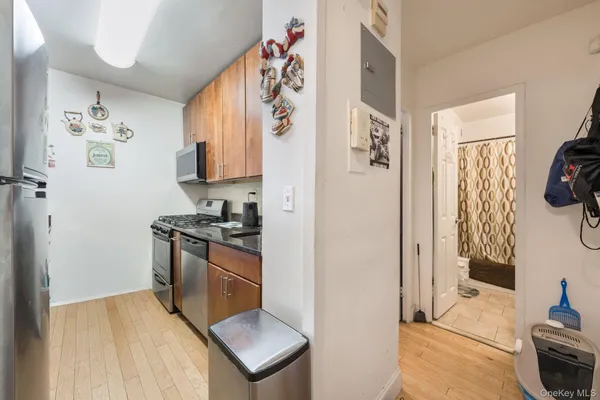 a kitchen with stainless steel appliances granite countertop a refrigerator and a stove