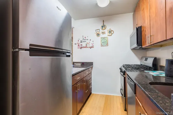 a kitchen with stainless steel appliances granite countertop a refrigerator and a stove