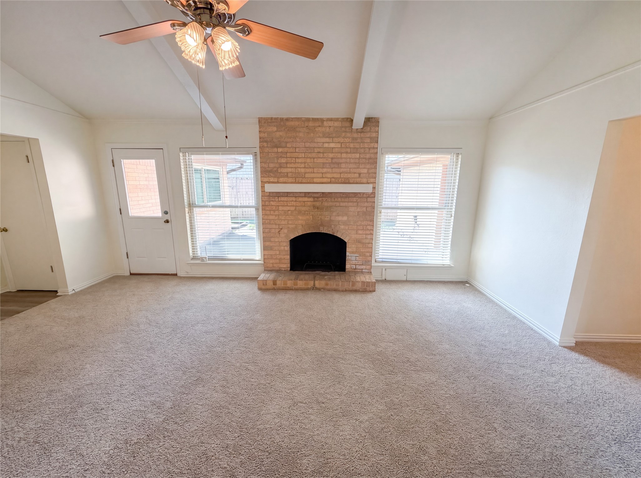 342 Queenstown Road Houston, TX 77015 - Photo 3 of 22 a view of a livingroom with a fireplace a ceiling fan and windows