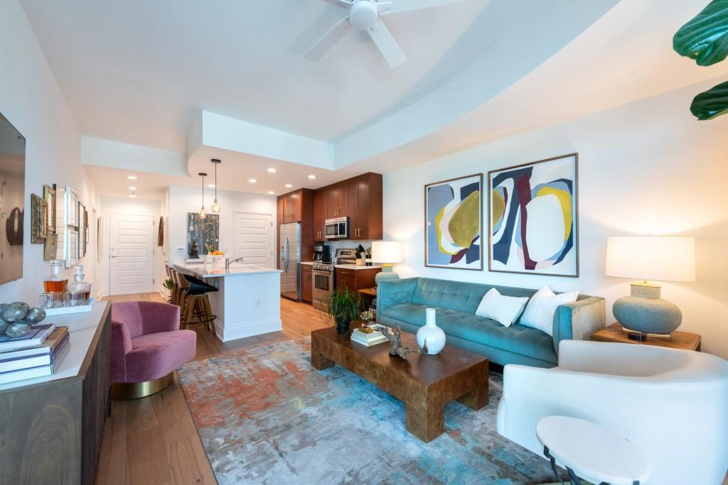 1080 Peachtree Street Northeast, Unit 1906 Atlanta, GA 30309 - Photo 11 of 46 a living room with fireplace furniture and a kitchen view