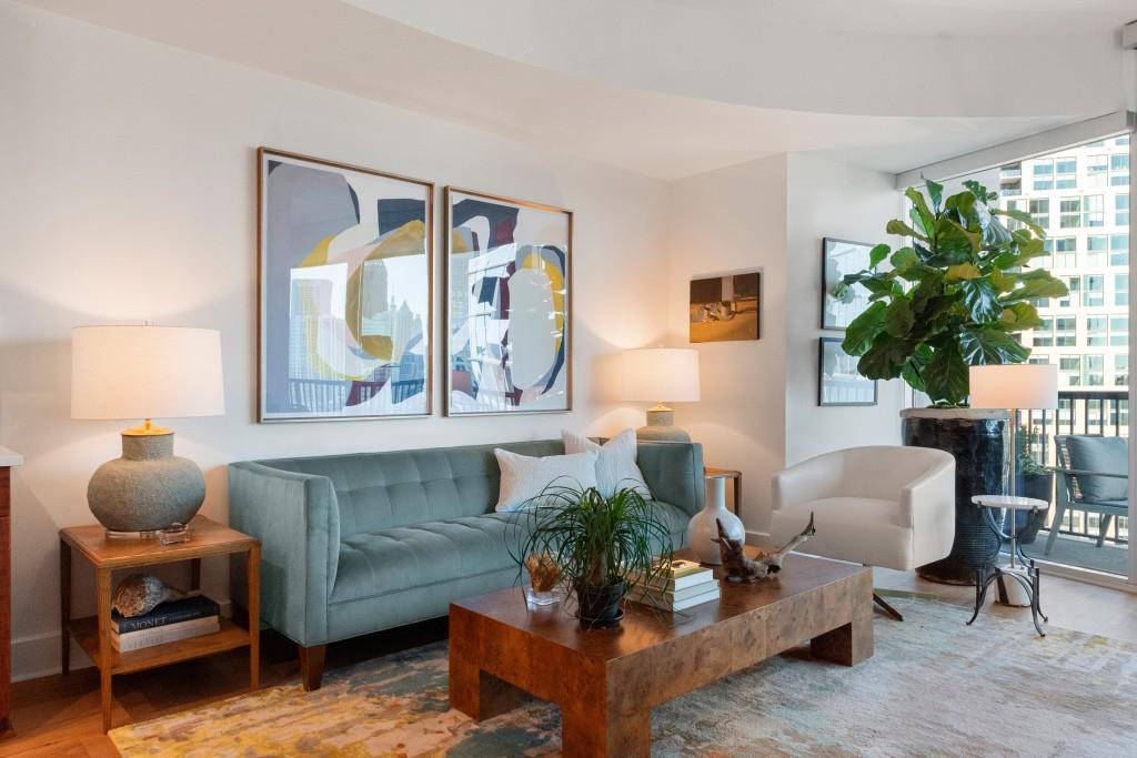 1080 Peachtree Street Northeast, Unit 1906 Atlanta, GA 30309 - Photo 12 of 46 a living room with furniture and a potted plant