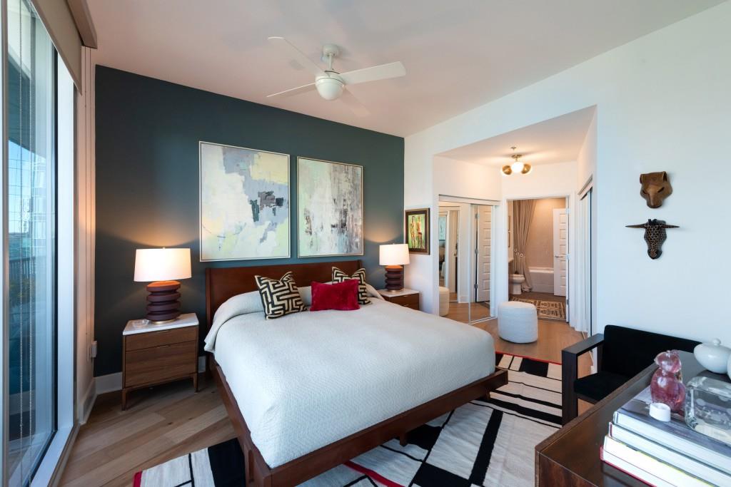 1080 Peachtree Street Northeast, Unit 1906 Atlanta, GA 30309 - Photo 20 of 46 a bedroom with a bed and wooden floor