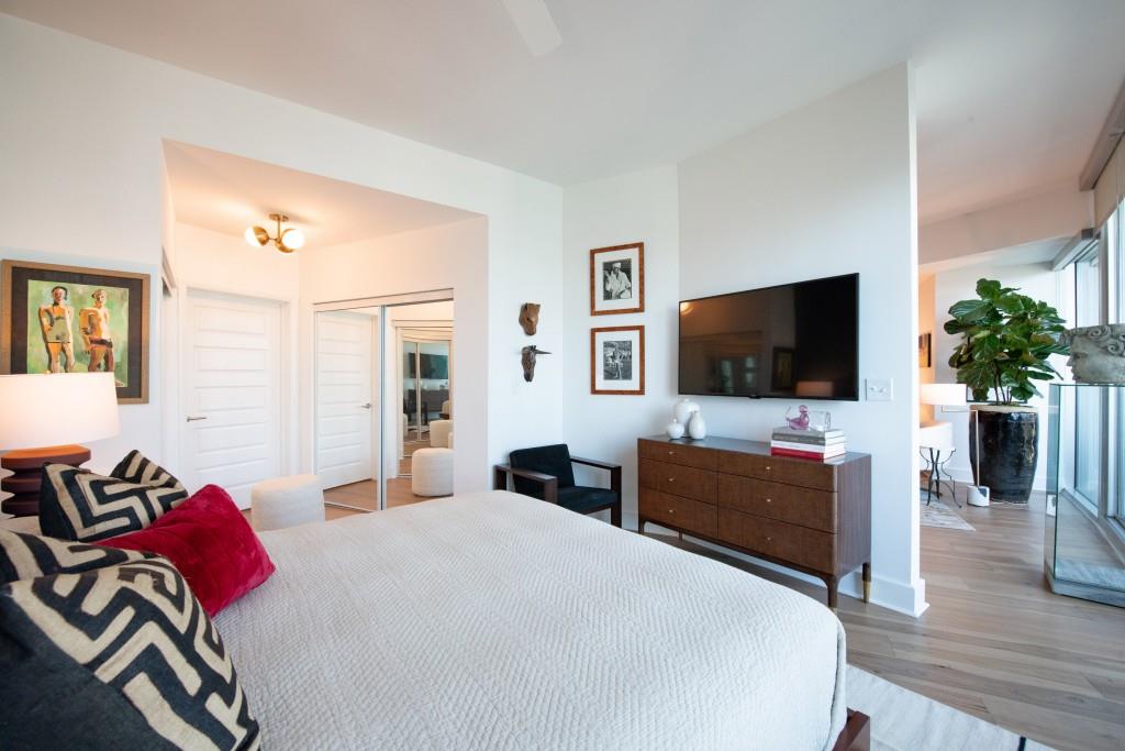 1080 Peachtree Street Northeast, Unit 1906 Atlanta, GA 30309 - Photo 22 of 46 a bedroom with a bed and a flat screen tv