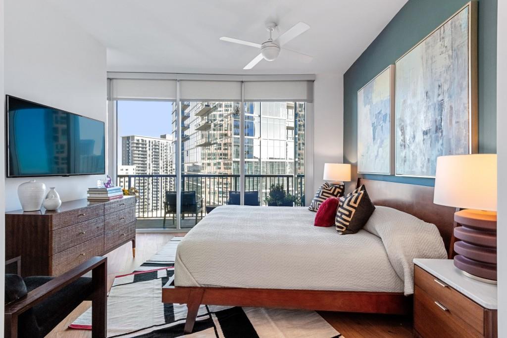 1080 Peachtree Street Northeast, Unit 1906 Atlanta, GA 30309 - Photo 24 of 46 a bedroom with a bed and large window