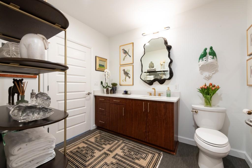 1080 Peachtree Street Northeast, Unit 1906 Atlanta, GA 30309 - Photo 28 of 46 a bathroom with a toilet sink and mirror