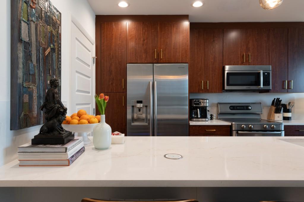 1080 Peachtree Street Northeast, Unit 1906 Atlanta, GA 30309 - Photo 3 of 46 a kitchen with kitchen island granite countertop a refrigerator and a stove top oven