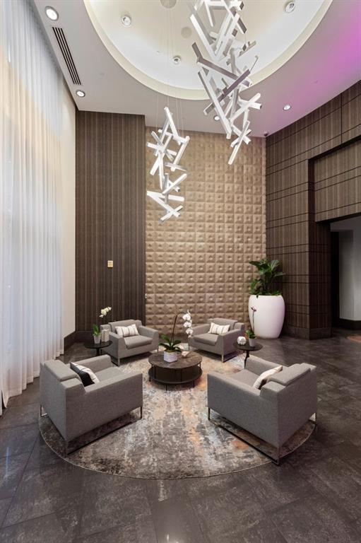 1080 Peachtree Street Northeast, Unit 1906 Atlanta, GA 30309 - Photo 32 of 46 a living room with furniture and a fireplace