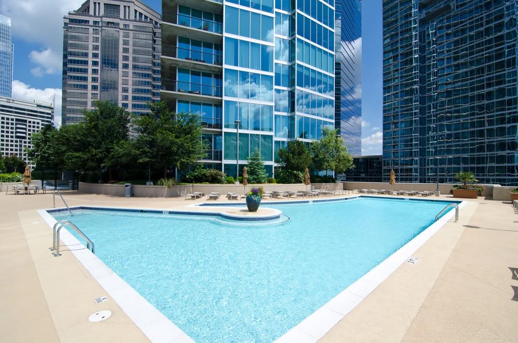 1080 Peachtree Street Northeast, Unit 1906 Atlanta, GA 30309 - Photo 38 of 46 a swimming pool with outdoor seating and yard