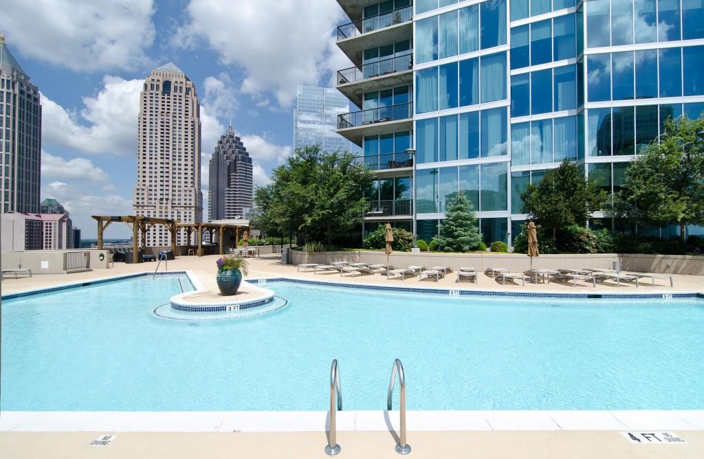 1080 Peachtree Street Northeast, Unit 1906 Atlanta, GA 30309 - Photo 39 of 46 a swimming pool with outdoor seating and yard