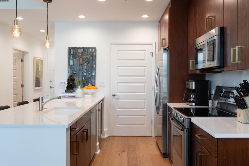 1080 Peachtree Street Northeast, Unit 1906 Atlanta, GA 30309 - Photo 4 of 46 a kitchen with a sink stove and refrigerator