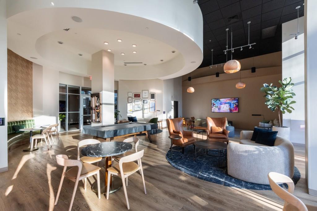 1080 Peachtree Street Northeast, Unit 1906 Atlanta, GA 30309 - Photo 44 of 46 a living room with furniture and a potted plant