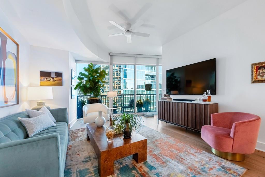 1080 Peachtree Street Northeast, Unit 1906 Atlanta, GA 30309 - Photo 9 of 46 a living room with furniture and a flat screen tv