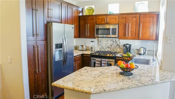 a kitchen with a refrigerator a stove and a sink