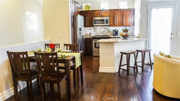 a view of a dining room with furniture and wooden floor