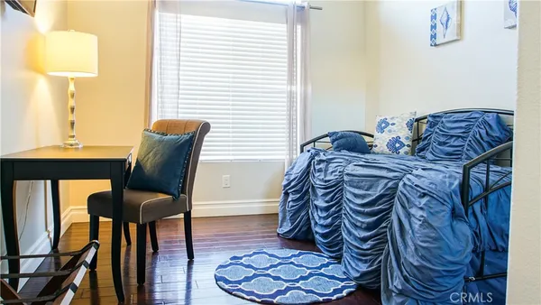 a bedroom with a bed and a chair