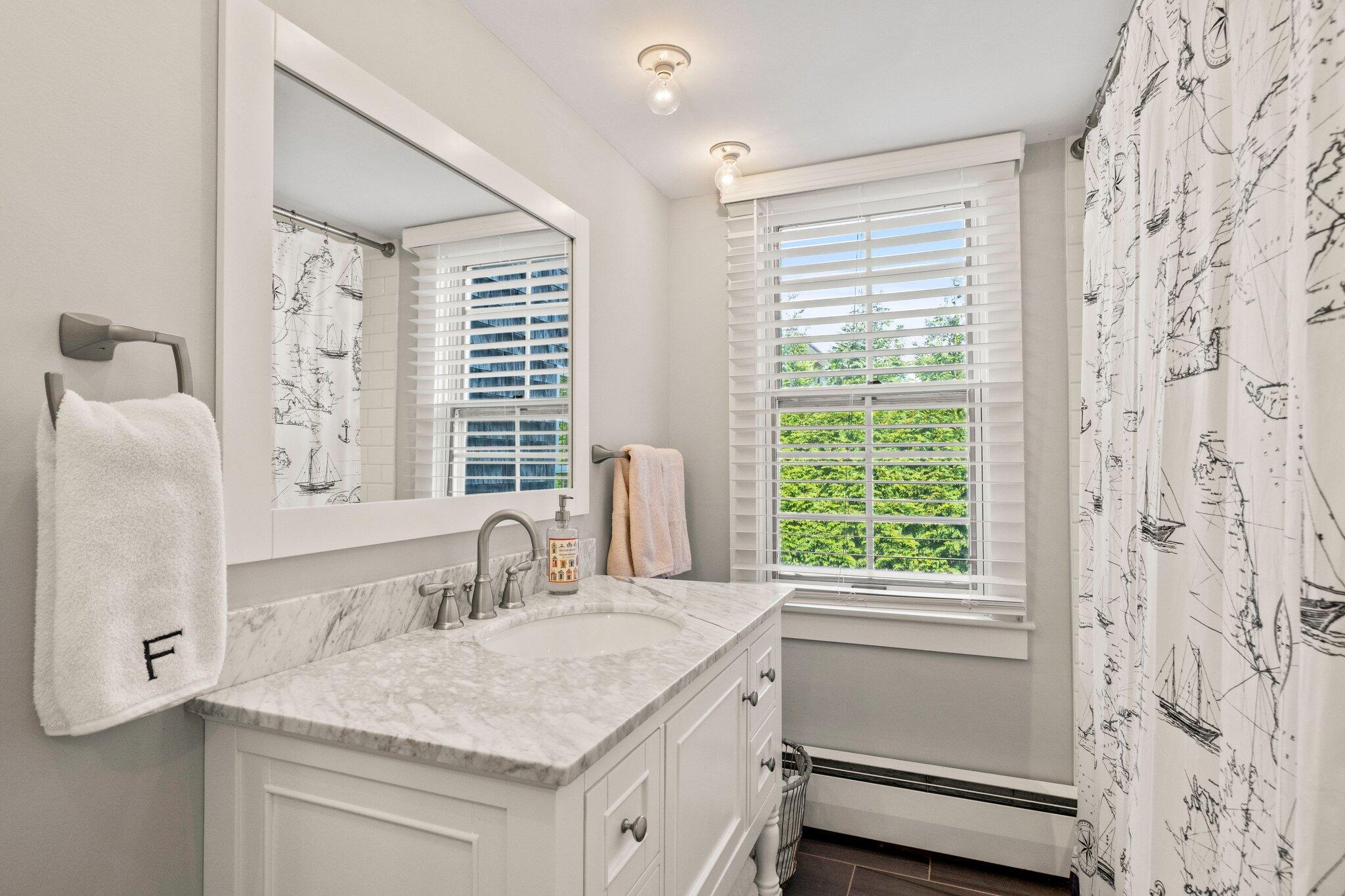47 Quasson Road Chatham, MA 02633 - Photo 21 of 47 a bathroom with a granite countertop sink and a window
