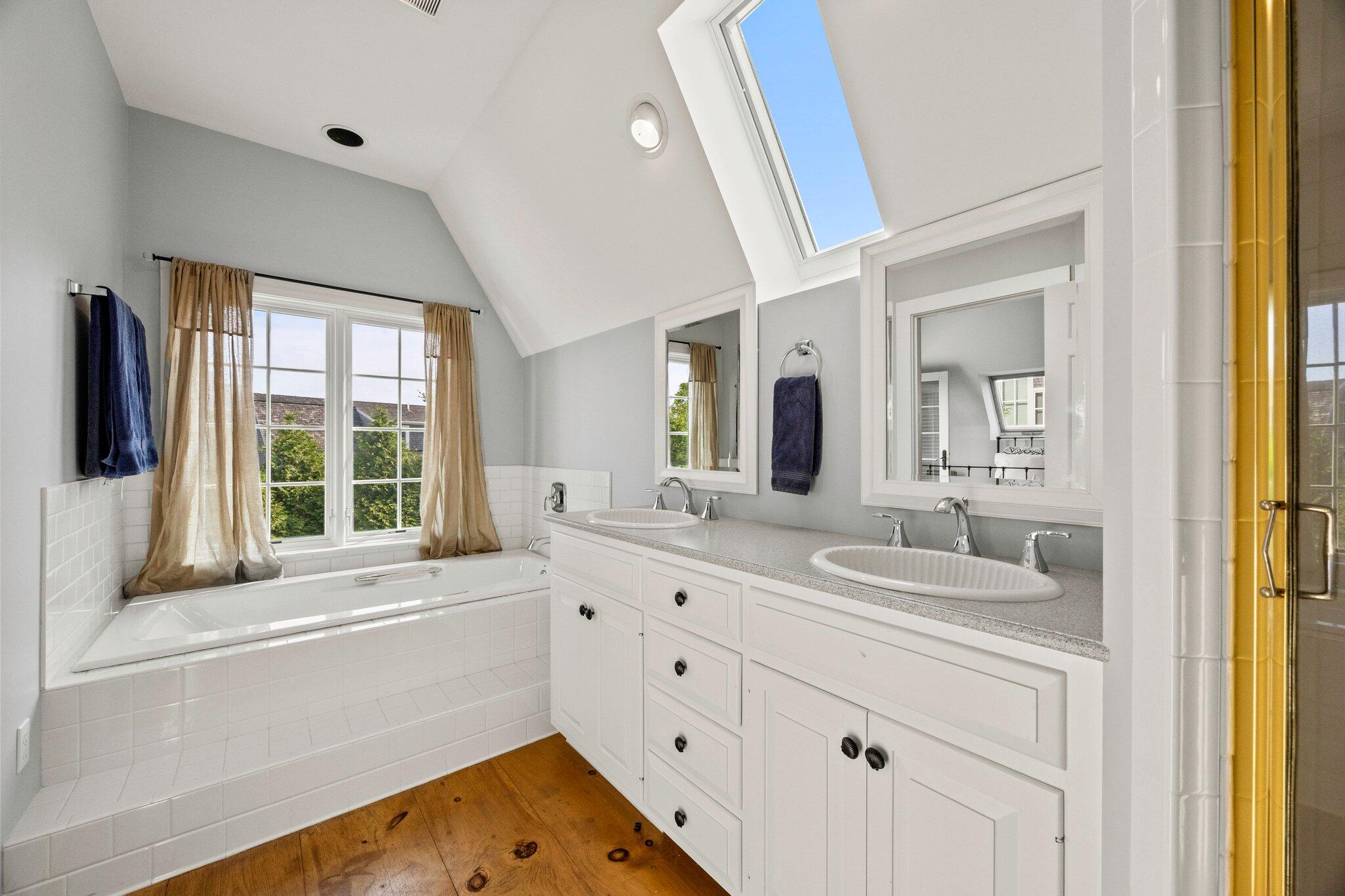 47 Quasson Road Chatham, MA 02633 - Photo 29 of 47 a bathroom with a sink and a large mirror next to a window