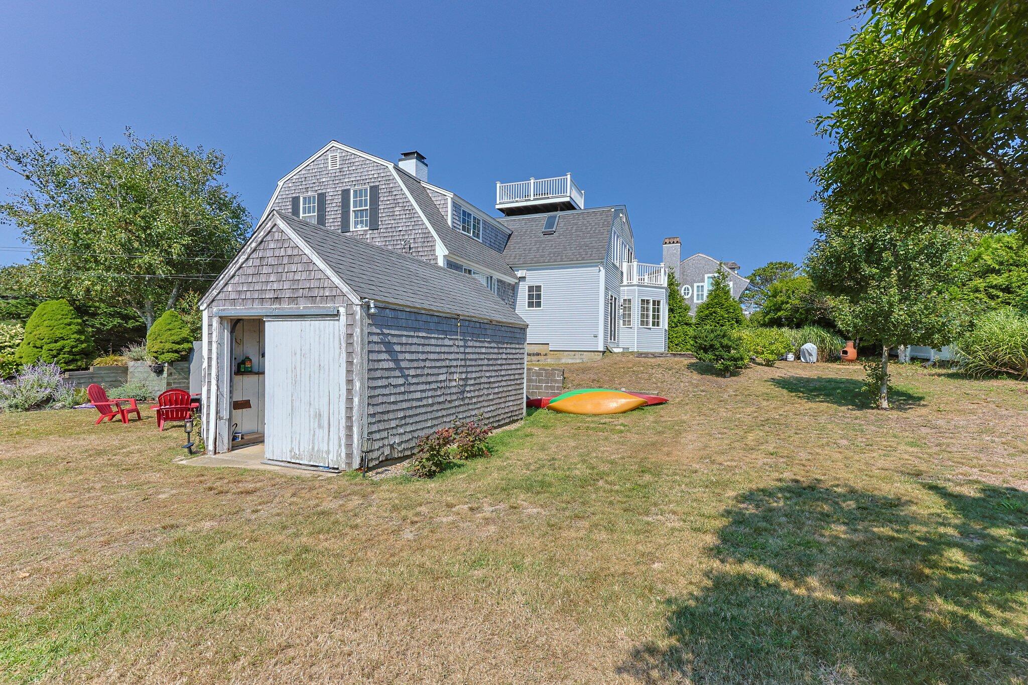47 Quasson Road Chatham, MA 02633 - Photo 33 of 47 a view of a house with a yard and large tree