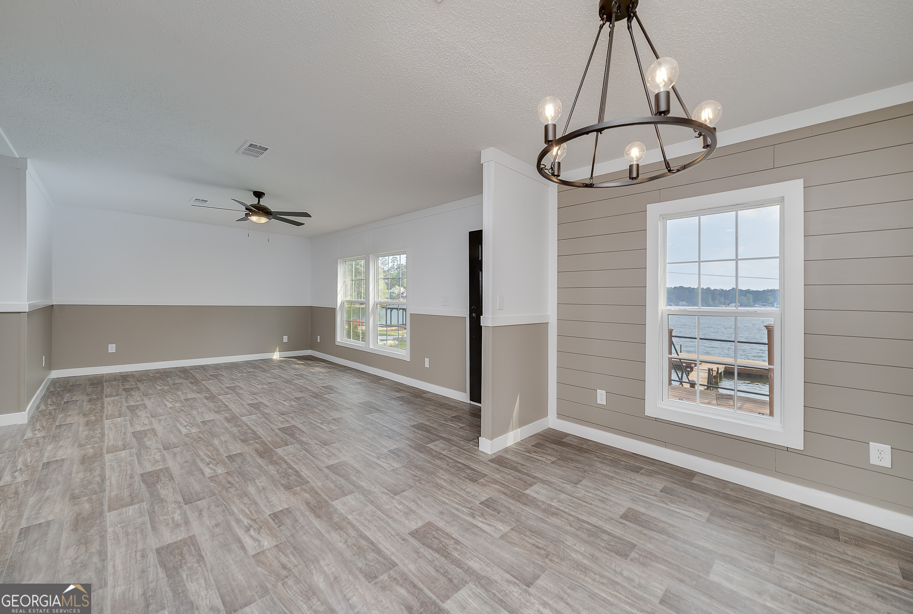 595 Barnetts Bridge Road Jackson, GA 30233 - Photo 17 of 47 an empty room with windows and chandelier