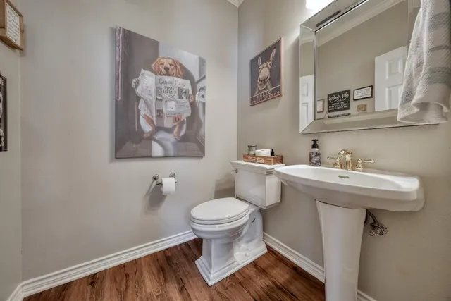 a bathroom with a sink toilet and a mirror