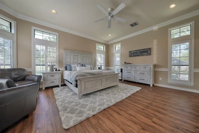 a spacious bedroom with a bed and a couch